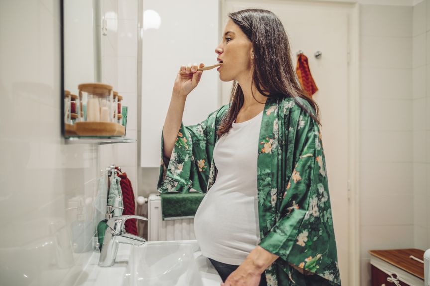 Schwangere putzt sich die Zähne
