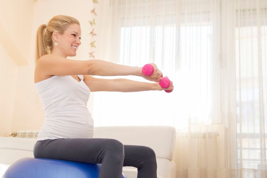 Schwangere trainiert auf dem Gymball