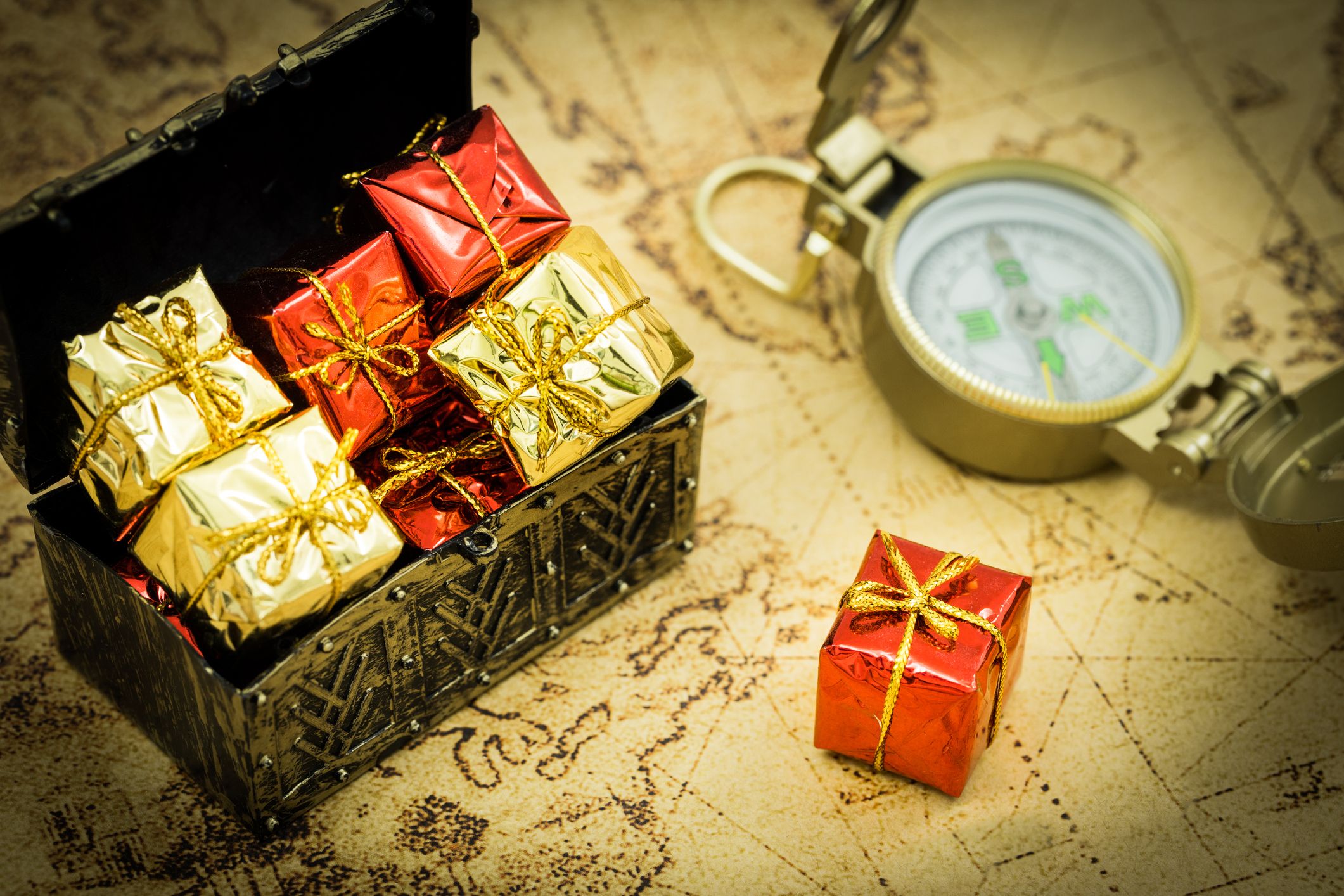 Schatztruhe mit Geschenken, Kompass und Landkarte