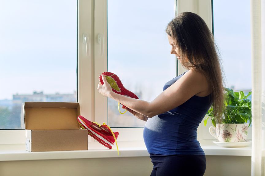 Schwangere packt Schuhe aus