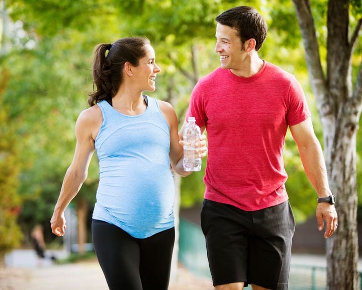 Werdende Eltern beim Sport mit Trinkflasche