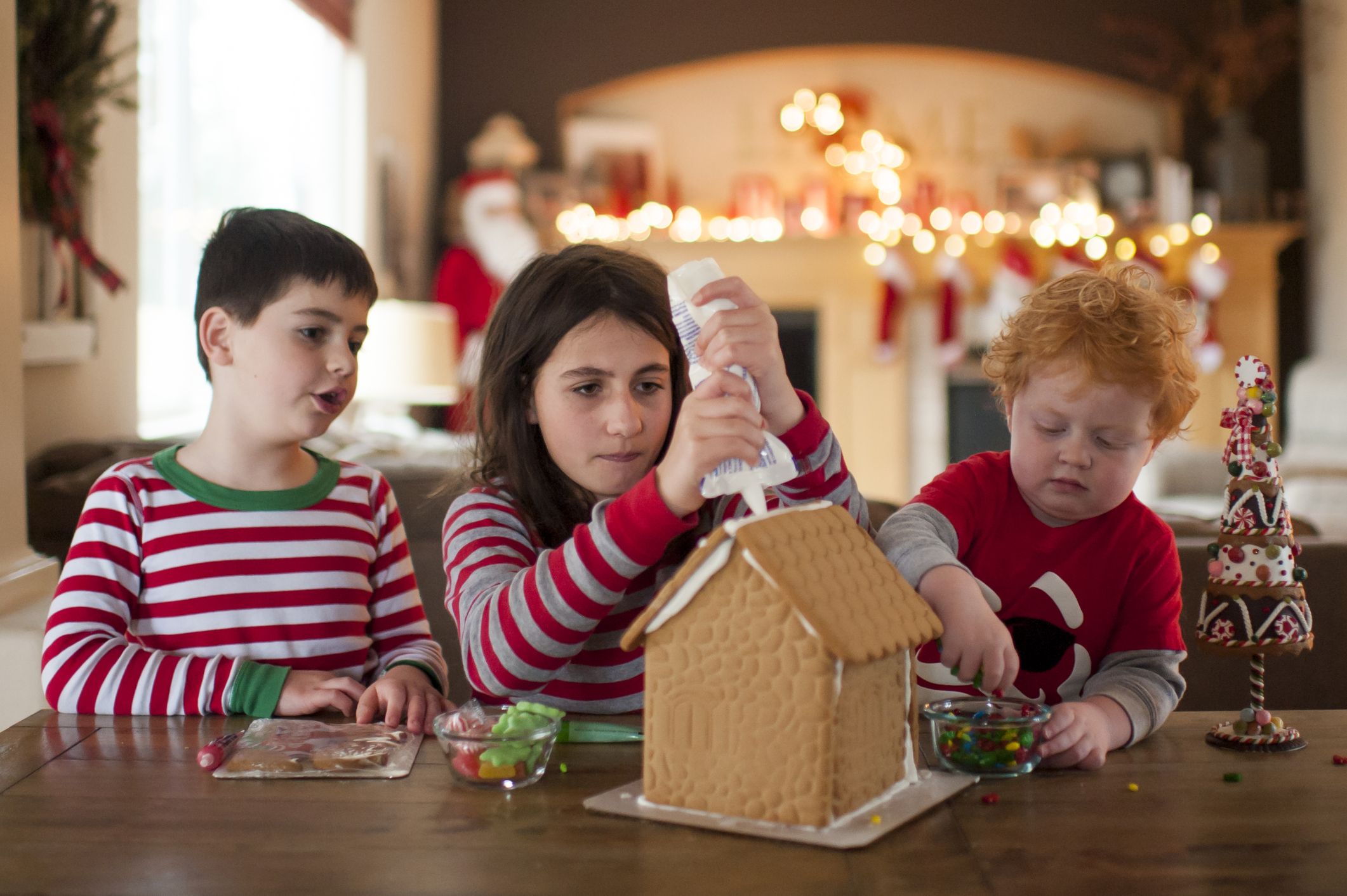 Kinder dekorieren ein Lebkuchenhaus