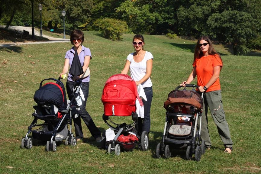 Drei Mütter mit Kinderwagen im Park